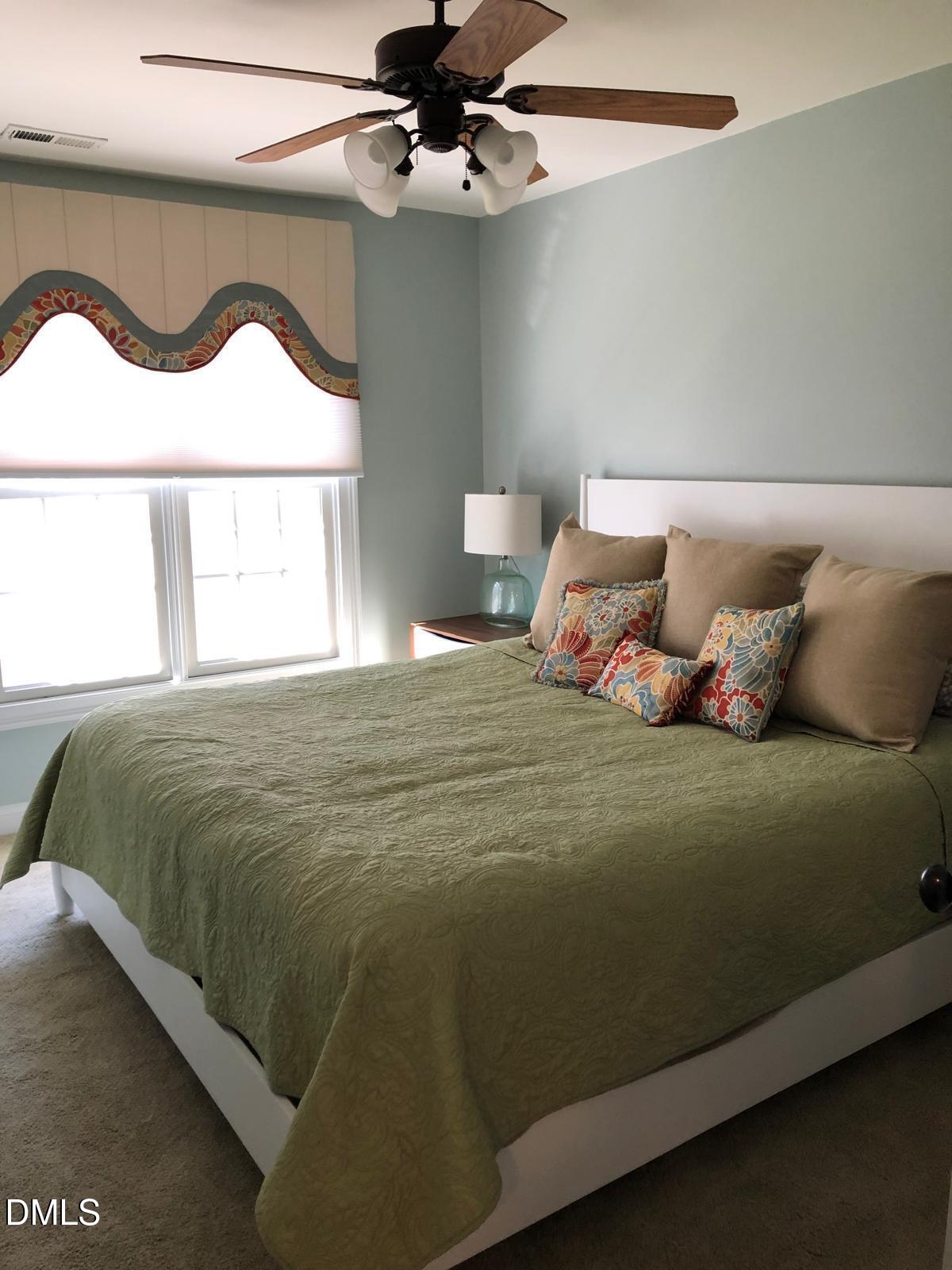 133 Fort Jackson Road Morrisville, NC 27560 - Photo 20 of 25 a bedroom with a bed and a painting on the wall