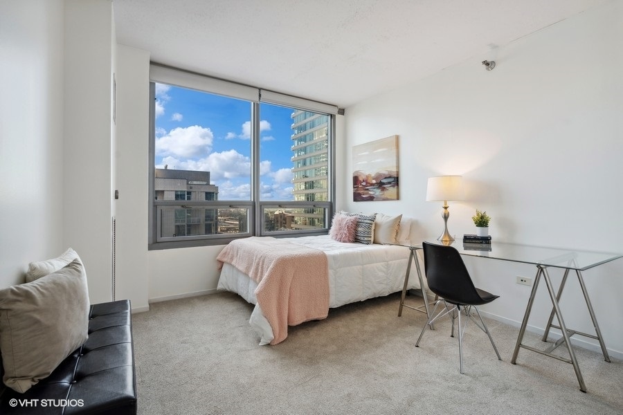 701 South Wells Street, Unit 1904 Chicago, IL 60607 - Photo 13 of 22 a bed room with a bed and a chair