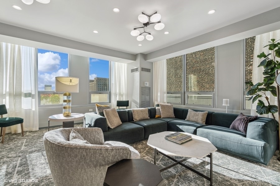 701 South Wells Street, Unit 1904 Chicago, IL 60607 - Photo 17 of 22 a living room with furniture and a large window