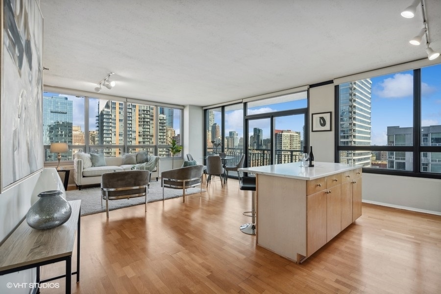 701 South Wells Street, Unit 1904 Chicago, IL 60607 - Photo 2 of 22 a living room with furniture and a large window