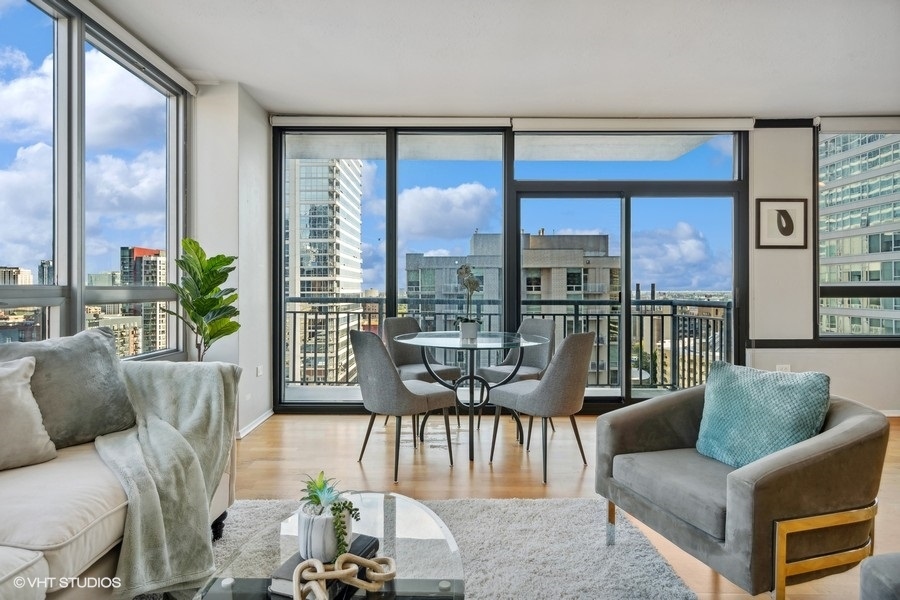 701 South Wells Street, Unit 1904 Chicago, IL 60607 - Photo 4 of 22 a living room with furniture and floor to ceiling windows