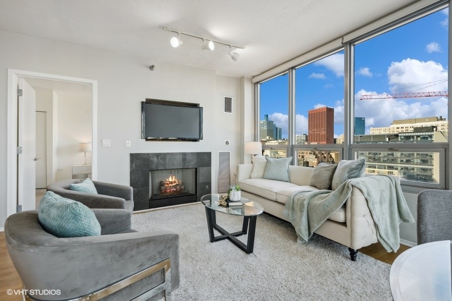701 South Wells Street, Unit 1904 Chicago, IL 60607 - Photo 5 of 22 a living room with furniture and a fireplace