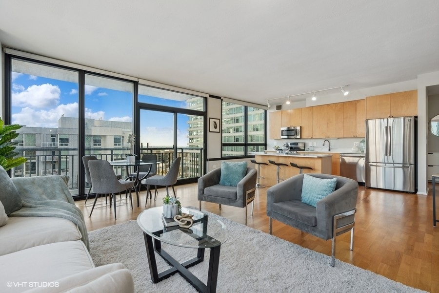 701 South Wells Street, Unit 1904 Chicago, IL 60607 - Photo 6 of 22 a living room with furniture and a large window