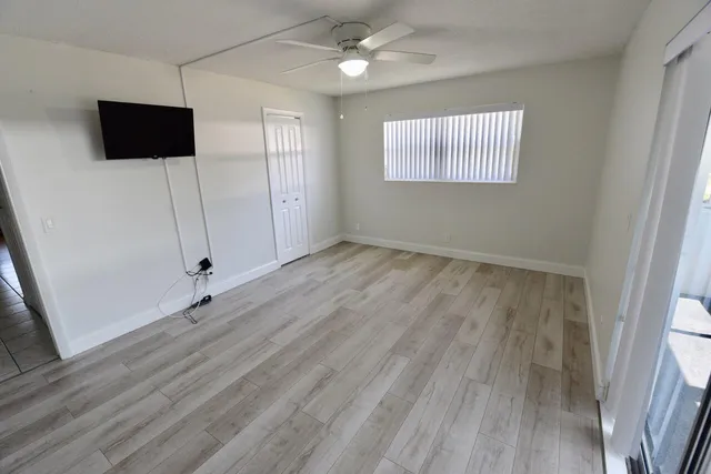wooden floor in an empty room with a window