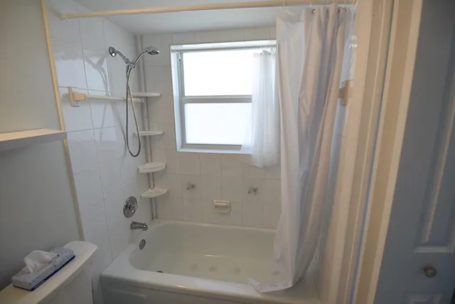a bathroom with a bathtub and a window