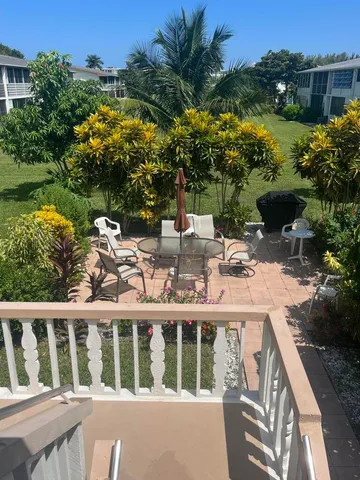 a view of a house with a backyard and a deck