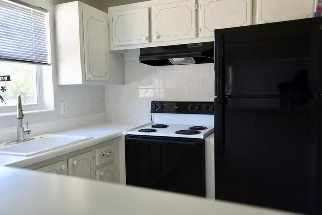 a kitchen with a sink and cabinets