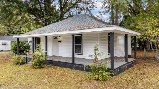 a front view of house with yard outdoor seating and garage