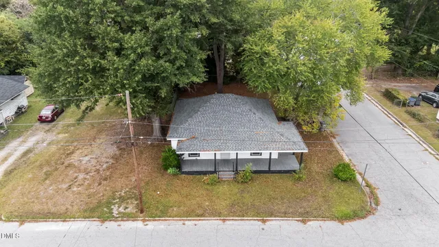 a aerial view of a house with large trees