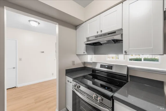 a kitchen with wooden cabinets and a stove top oven