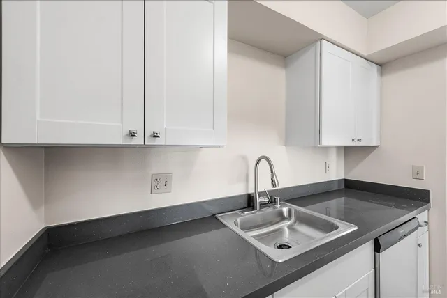 a kitchen with a sink and cabinets