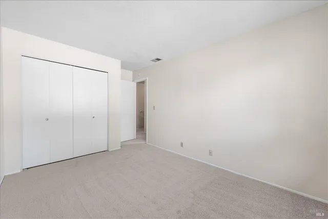 a view of a white house with a yard