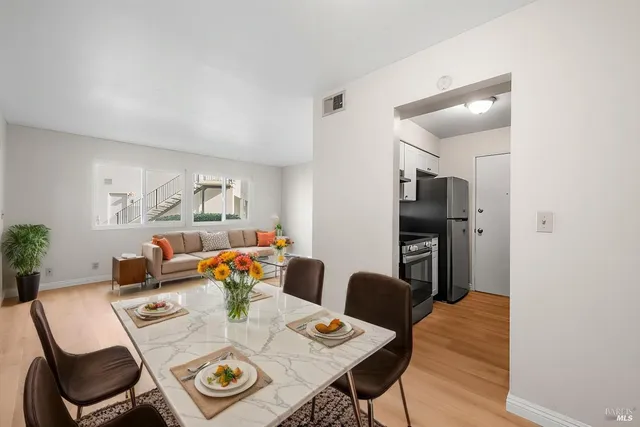 a view of a dining room with furniture and a potted plant