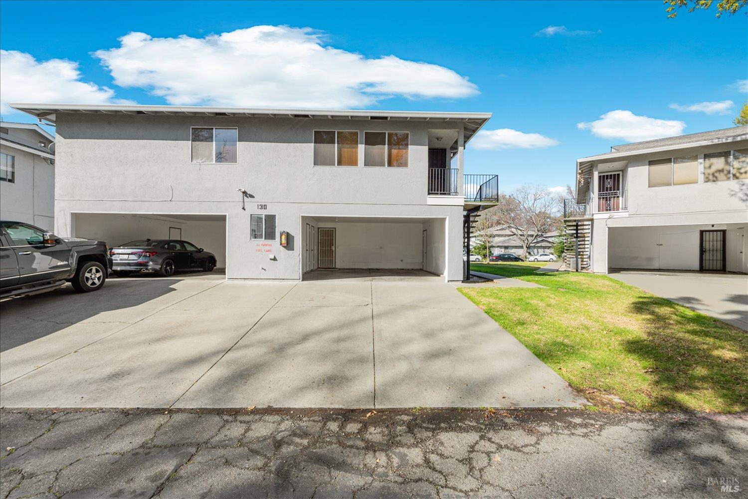 130 Del Rio Circle, Unit 2 Vacaville, CA 95687 - Photo 22 of 33 a view of a white house with a yard