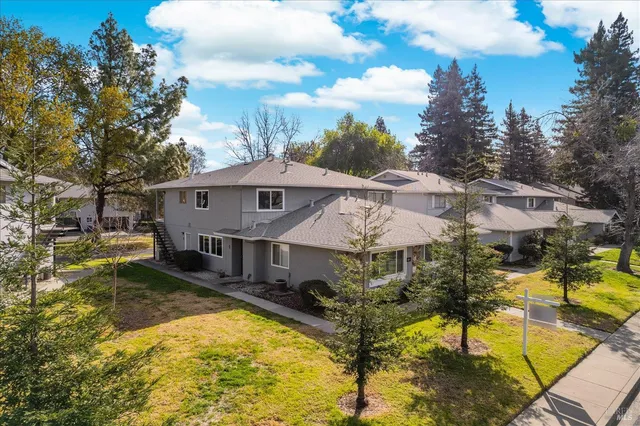 an aerial view of a house with swimming pool and ocean view