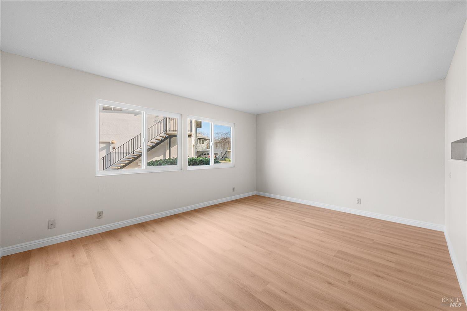 130 Del Rio Circle, Unit 2 Vacaville, CA 95687 - Photo 5 of 33 an empty room with wooden floor and windows