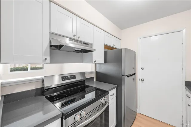 a kitchen with appliances and cabinets