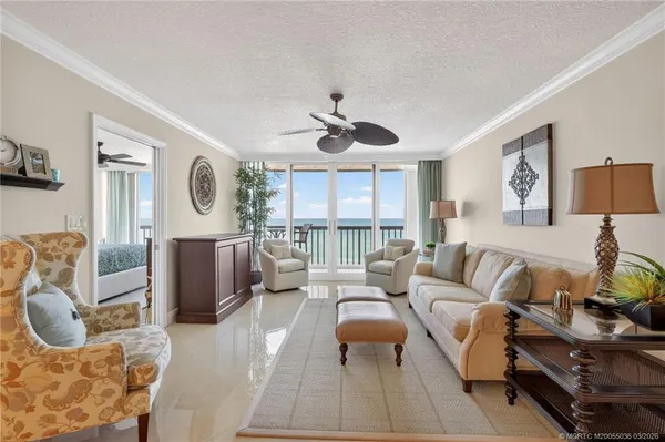 a living room with furniture a flat screen tv and a large window
