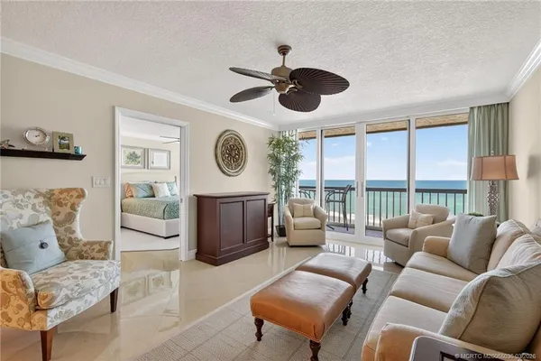 a living room with furniture a large window and a clock