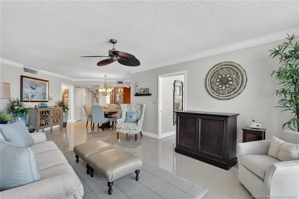a living room with furniture a clock and a fireplace