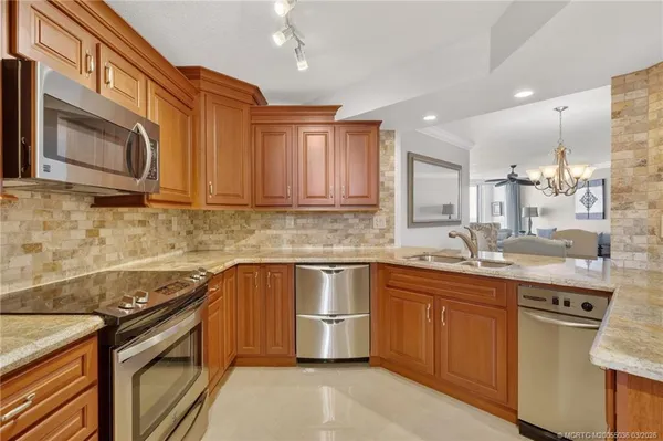 a kitchen that has a sink and a stove