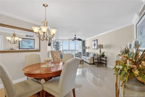 a view of a dining room with furniture and chandelier