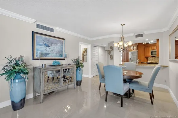a view of a dining room with furniture and chandelier