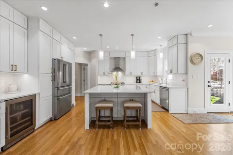 a large kitchen with a table and chairs