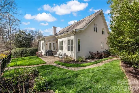 a bathroom with a tub a potted plant and a shower