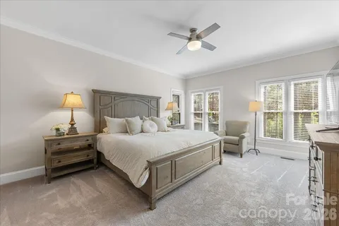 a en suite bathroom with a granite countertop double vanity sink and a mirror