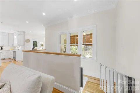 a kitchen with a sink cabinets and wooden floor