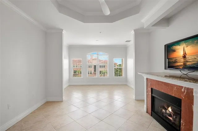 a view of an empty room with a fireplace and a window