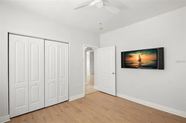 a view of a livingroom with an empty space and a ceiling fan