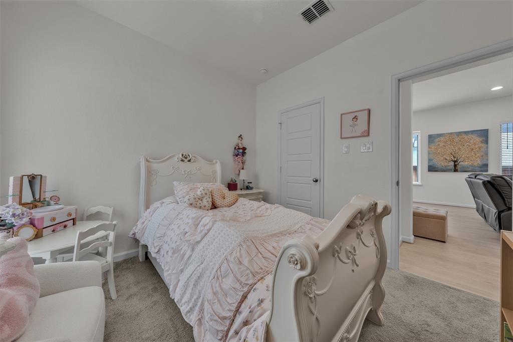228 Palo Duro Bend Rhome, TX 76078 - Photo 12 of 35 a bedroom with a bed and wooden floor