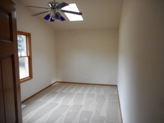21 South Elmhurst Road Prospect Heights, IL 60070 - Photo 13 of 13 an empty room with windows and fan
