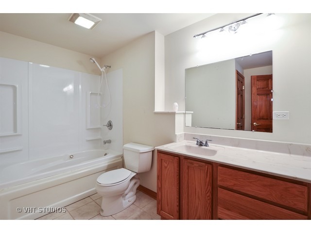 21 South Elmhurst Road Prospect Heights, IL 60070 - Photo 8 of 13 a bathroom with a sink a toilet and a bathtub