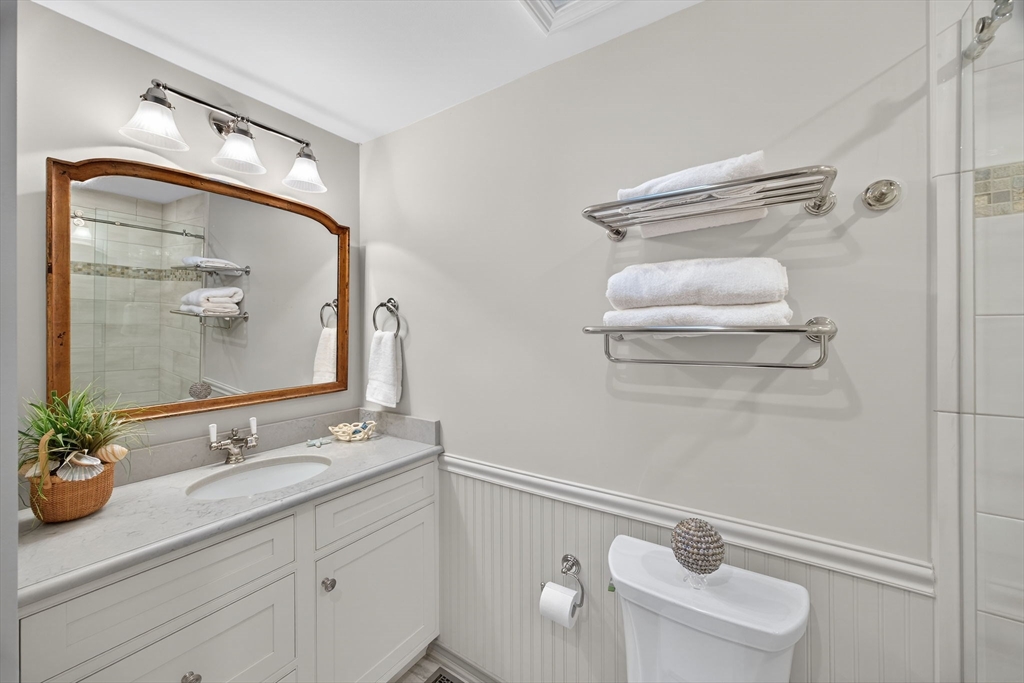 31 High Head Road Dennis, MA 02660 - Photo 29 of 32 a bathroom with a toilet sink and mirror