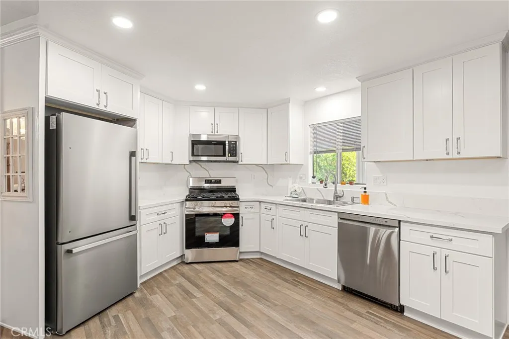 35218 Fir, Unit 183 Yucaipa, CA 92399 - Photo 12 of 35 a kitchen with white cabinets and white appliances