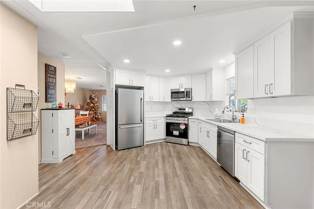 35218 Fir, Unit 183 Yucaipa, CA 92399 - Photo 13 of 35 a kitchen with white cabinets and stainless steel appliances