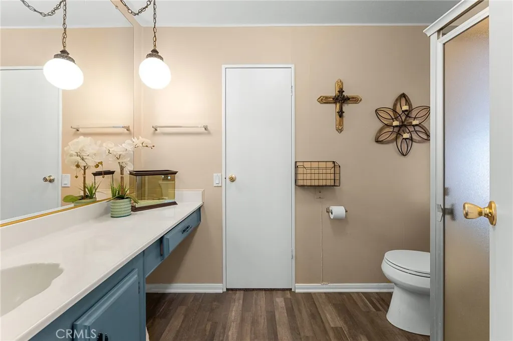 35218 Fir, Unit 183 Yucaipa, CA 92399 - Photo 24 of 35 a bathroom with a sink a toilet and mirror