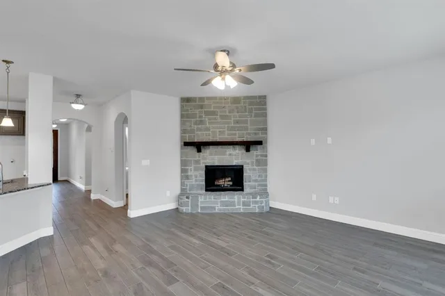 a view of a livingroom with a fireplace wooden floor and fire place
