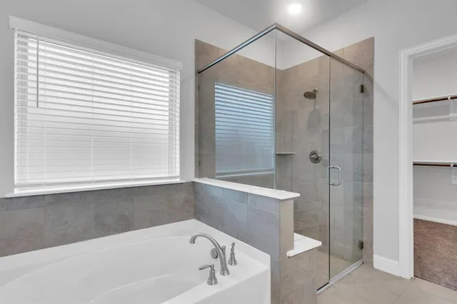 a bathroom with a bathtub and a shower