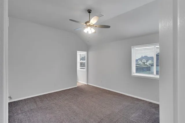 a view of a livingroom with a ceiling fan and window