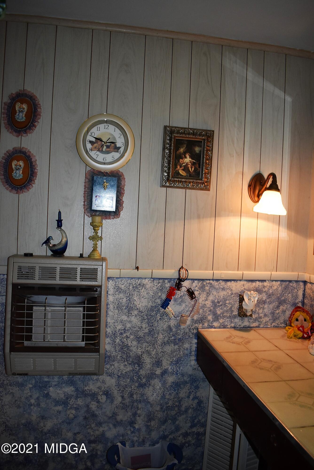 4238 Jones Road Macon, GA 31216 - Photo 19 of 31 a kitchen with a sink and a stove with chairs