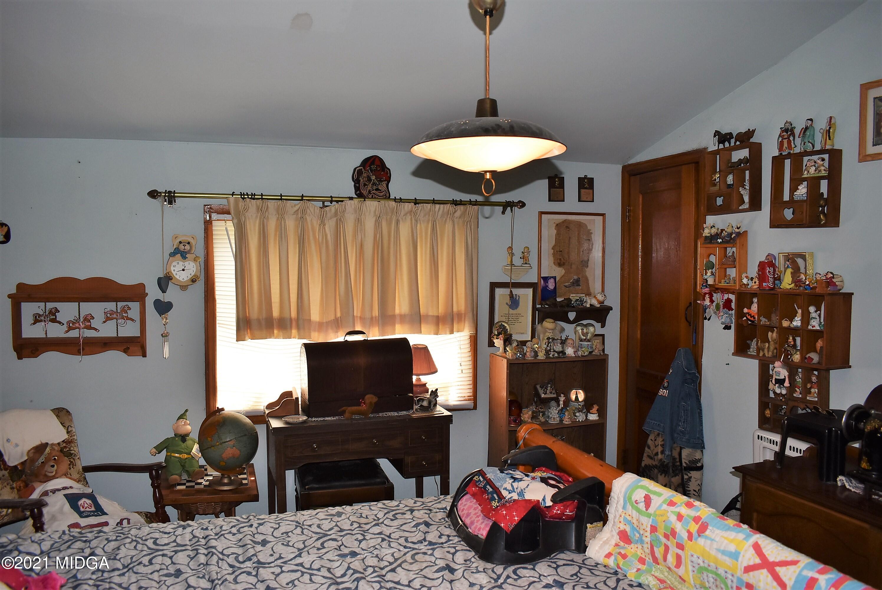 4238 Jones Road Macon, GA 31216 - Photo 23 of 31 a bedroom with furniture and a flat screen tv