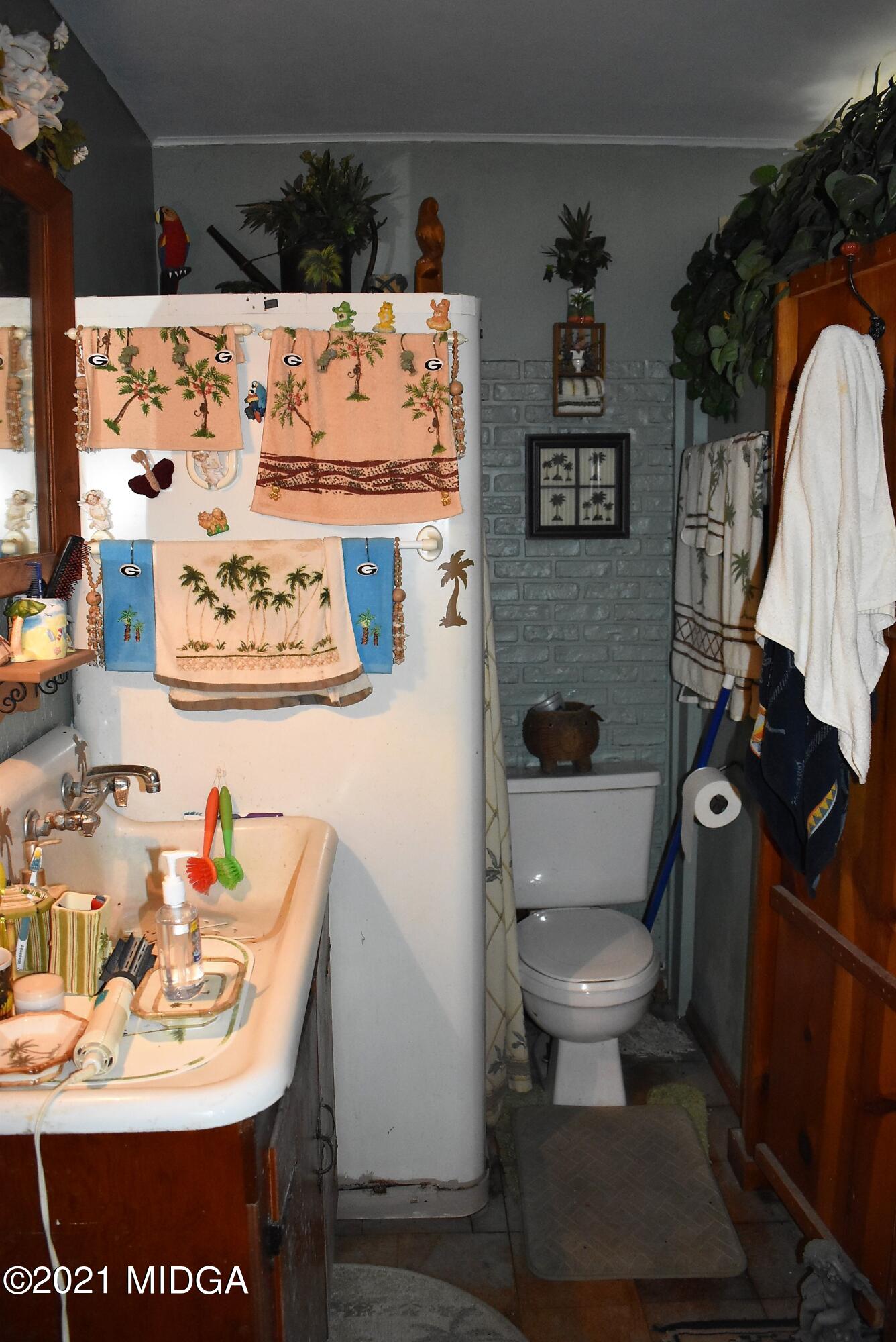 4238 Jones Road Macon, GA 31216 - Photo 25 of 31 a bathroom with a sink toilet and mirror