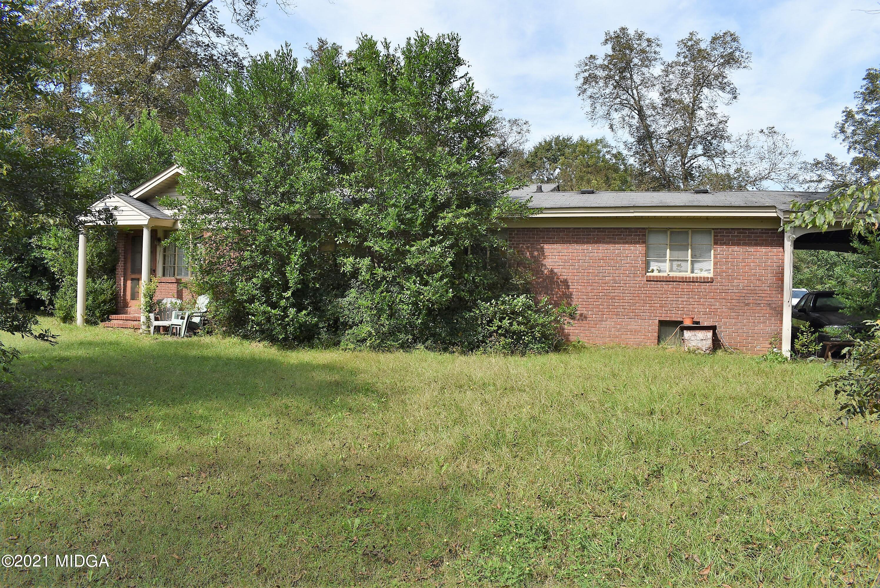 4238 Jones Road Macon, GA 31216 - Photo 30 of 31 a front view of house with yard and trees