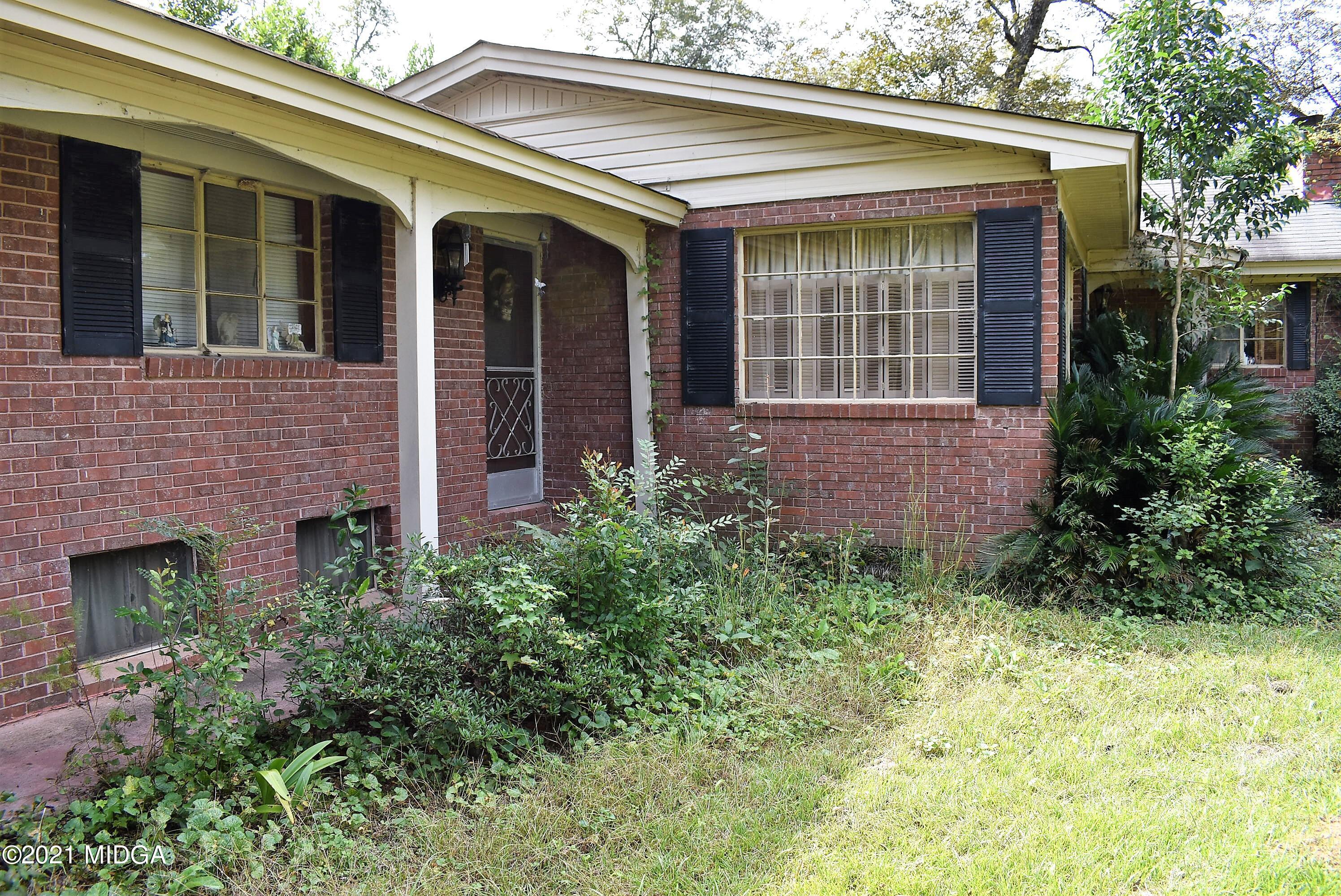 4238 Jones Road Macon, GA 31216 - Photo 3 of 31 front view of a brick house with a yard