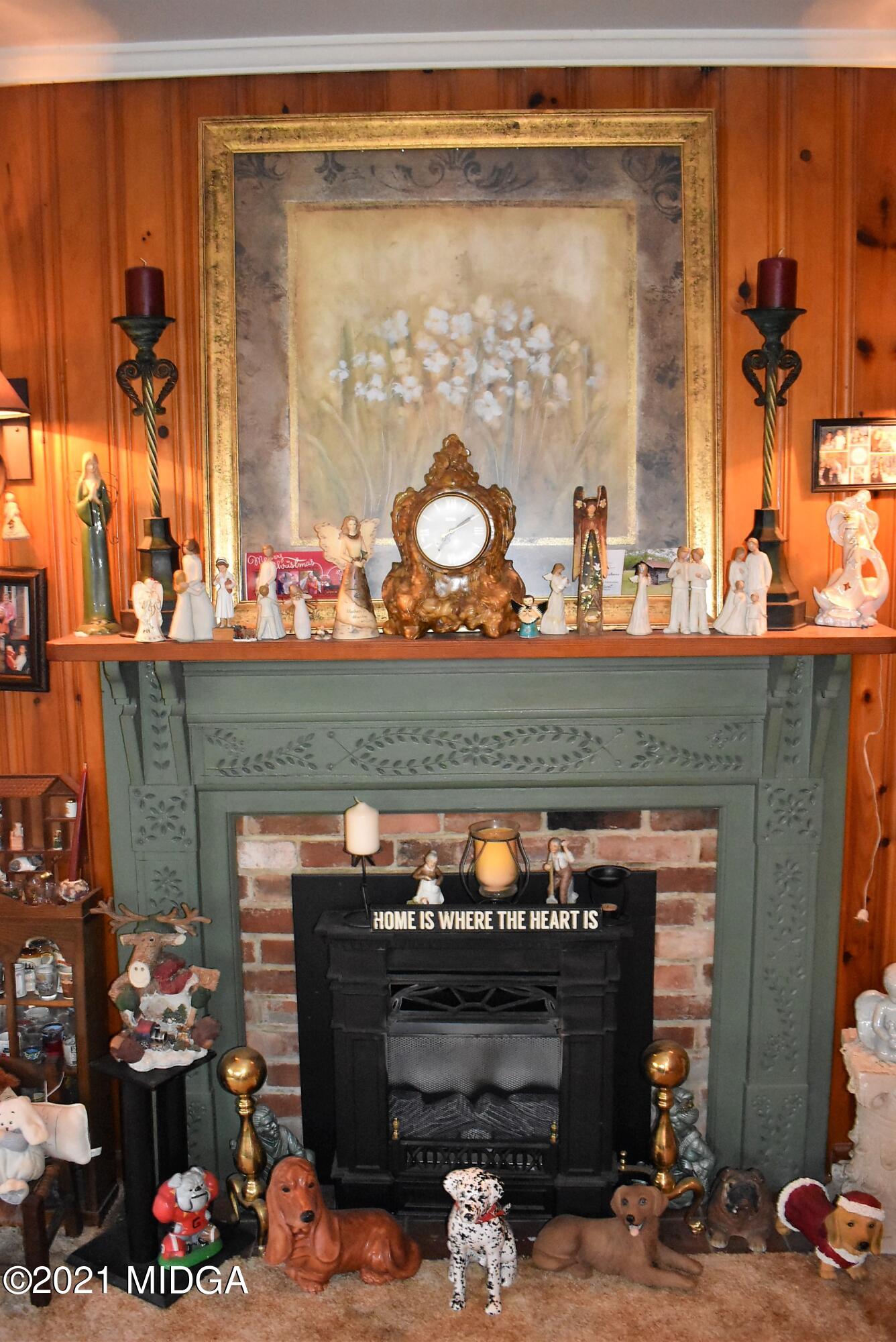 4238 Jones Road Macon, GA 31216 - Photo 8 of 31 a room with a fireplace a potted plant and a fireplace