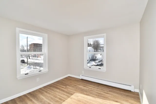 a view of wooden floor and windows in a room